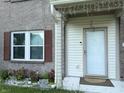 Close up on a charming front porch with decorative lights and brick accents at 6604 Heritage Hill Dr, Indianapolis, IN 46237