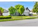 Attractive home showcasing a white brick exterior, an attached garage, and mature trees in the yard at 6897 Abercon Trl, Noblesville, IN 46062