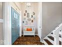 Welcoming entryway features tile floors, a bench, and decorative wall art at 7345 Monon Cir, Indianapolis, IN 46256