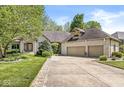 Charming brick home with a well-manicured lawn and three-car garage at 7421 Meadow Violet Ct, Avon, IN 46123