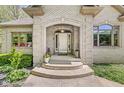 Inviting entrance with a beautiful arched doorway and manicured landscaping at 7421 Meadow Violet Ct, Avon, IN 46123