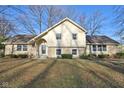 Beautiful exterior view of home featuring stone details, well-maintained lawn, and mature trees at 7910 Teel Way, Indianapolis, IN 46256