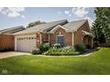 Well-maintained brick home with green lawn and mature landscaping at 8133 Hazen Way, Indianapolis, IN 46216