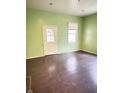 Empty living room with green walls, and dark hard wood floors at 834 N Temple Ave, Indianapolis, IN 46201