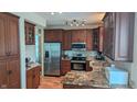 Updated kitchen featuring stainless steel appliances, granite countertops, and custom wood cabinetry at 8598 Lantern Farms Dr, Fishers, IN 46038