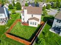 Aerial view of home showing spacious, fenced backyard with a small deck and green grass at 8644 N Deer Crossing Blvd, McCordsville, IN 46055