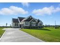 Beautiful home featuring manicured lawn, stone accents and long driveway at 963 Apryl Dr, Greenwood, IN 46143