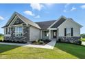 Lovely front exterior showcasing stone and brick accents, tasteful landscaping, and a well-maintained lawn at 963 Apryl Dr, Greenwood, IN 46143