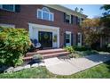 Inviting front entrance with a black door, brick steps, and landscaping at 11536 Woods Bay Ln, Indianapolis, IN 46236