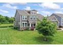 Attractive two-story home with a well-maintained lawn, and the pond nearby adds a great view at 12052 Northface Dr, Noblesville, IN 46060
