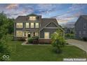 Charming two-story home with a beautifully landscaped front yard and classic architectural details enhanced virtually at 12052 Northface Dr, Noblesville, IN 46060