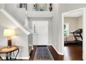 Bright foyer with staircase, hardwood floors, and a view into an adjacent room at 1286 Brookdale Ct, Franklin, IN 46131