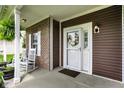 Inviting front porch with rocking chairs, decorative wreath, and charming curb appeal at 1286 Brookdale Ct, Franklin, IN 46131