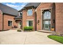 Close-up of a brick home exterior, highlighting the front entrance and architectural details at 12945 E 100 N, Columbus, IN 47203