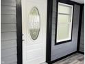Close-up of the front door with an decorative glass window and modern gray siding at 1417 N Belleview Pl, Indianapolis, IN 46222
