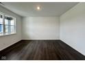 Bright bedroom featuring hardwood floors, a large window that fills the room with natural light, and neutral walls at 1534 Trichel Dr, Greenwood, IN 46143