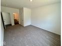 Neutral bedroom with carpeted floors and a view into an en-suite bathroom and closet at 1534 Trichel Dr, Greenwood, IN 46143