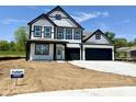 Charming two-story home boasting a modern black and white exterior design with attached garage at 1534 Trichel Dr, Greenwood, IN 46143