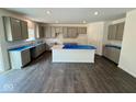 Spacious kitchen featuring gray cabinets, expansive countertops, and a large center island at 1534 Trichel Dr, Greenwood, IN 46143