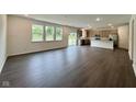 Open-concept living room boasts hardwood floors, recessed lighting, and a sliding glass door to the backyard at 1534 Trichel Dr, Greenwood, IN 46143