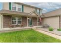 Quaint front porch with rocking chairs, an American flag, and a beautifully landscaped yard, creating a warm entrance at 1603 Quinn Creek Dr, Brownsburg, IN 46112