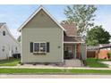 Charming home featuring a cozy front porch, fresh green grass, and beautiful landscaping at 1609 S G St, Elwood, IN 46036