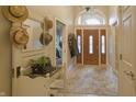 Elegant foyer features tile flooring, and a beautiful wooden door with transom window at 1614 Rosebud Ln # 83, Greenwood, IN 46143