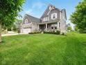 Charming two-story home with stone accents, manicured lawn, and inviting front porch at 165 N Bend Dr, Greenwood, IN 46142