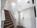 Bright foyer with high ceilings and a staircase leading to the upper level of the home at 17696 Arryne E Dr, Noblesville, IN 46062