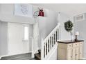 Bright foyer with white staircase and neutral walls, adorned with decorative accents at 18258 Rickety Dr, Westfield, IN 46074
