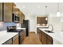Well-equipped kitchen features stainless steel appliances, ample counter space, and stylish wood cabinetry at 19725 Highclere Lane, Sheridan, IN 46069