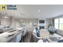 Open-concept living room and kitchen area with granite countertops, stainless steel appliances, and a cozy fireplace at 19725 Highclere Lane, Sheridan, IN 46069