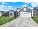 Beautiful single-Gathering home with blue siding, white garage door, and spacious concrete driveway at 19762 Highclere Lane, Sheridan, IN 46069