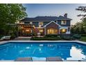 Beautiful backyard with a sparkling pool, lounge chairs, and a covered patio perfect for outdoor entertaining at 2055 Mulsanne Dr, Zionsville, IN 46077
