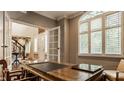 Bright home office with a large wooden desk, plantation shutters, and French doors at 2055 Mulsanne Dr, Zionsville, IN 46077