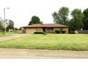 Classic ranch home with an attached garage and meticulously maintained front lawn at 2315 Redfern Dr, Indianapolis, IN 46227