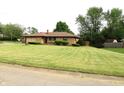 Well-maintained ranch-style home with a sprawling green lawn and mature trees at 2315 Redfern Dr, Indianapolis, IN 46227