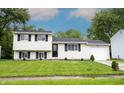 Charming split-level home with a well-manicured lawn and attached one car garage at 2740 Pawnee Dr, Indianapolis, IN 46229