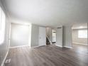 Spacious living room with wood-look flooring and view of kitchen at 2740 Pawnee Dr, Indianapolis, IN 46229