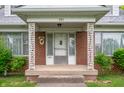 Close-up of the front porch featuring decorative columns and the front door at 301 N Kitley Ave, Indianapolis, IN 46219