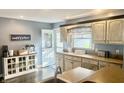 Bright kitchen with custom cabinets, a view to the yard, and stainless steel appliances at 310 Styleline Dr, Mooresville, IN 46158