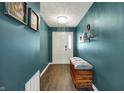 Stylish entryway with wood-look flooring, bench seating, and decoratively painted walls at 3214 Limber Pine Dr, Whiteland, IN 46184