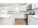 Well lit kitchen featuring stainless steel appliances, solid countertops and durable flooring at 3226 Promenade Way, Brownsburg, IN 46112
