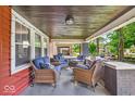Relaxing front porch with comfortable wicker seating and charming curb appeal at 405 N Drexel Ave, Indianapolis, IN 46201
