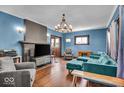 Bright living room with hardwood floors, a decorative fireplace, and comfortable seating at 405 N Drexel Ave, Indianapolis, IN 46201