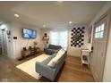 Cozy living room with hardwood floors, comfortable seating, and a modern entertainment center at 426 St Paul St, Indianapolis, IN 46201