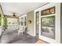 Spacious covered front porch with a swing, rocking chair, and access to the home's entrance at 5002 Broadway St, Indianapolis, IN 46205