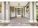 Inviting covered front porch with classic columns, a charming entrance, and a hanging bicycle decor at 5002 Broadway St, Indianapolis, IN 46205