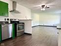Charming kitchen featuring stainless steel appliances, green cabinets, and hardwood floors flowing into an open layout at 503 Elmhurst Pl, Whiteland, IN 46184