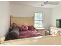 Cozy bedroom with a wooden bed frame, soft lighting, and a window view, creating a peaceful atmosphere at 5200 N Leslie Dr, Muncie, IN 47304